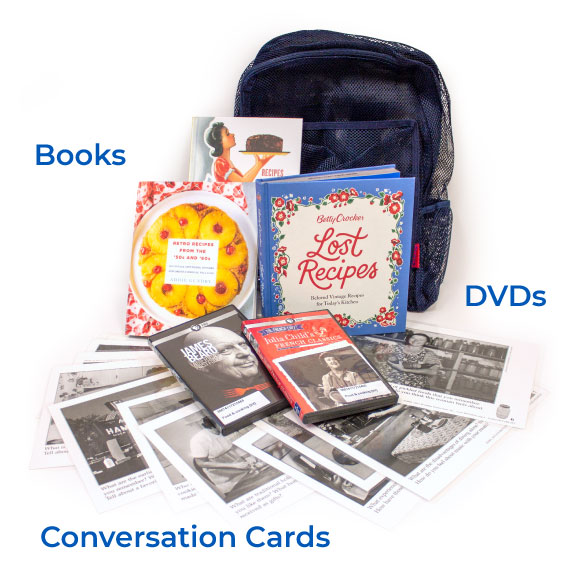 Image of a caregiver kit containing three books about food, two DVD, a variety of conversation cards with historic images and a prompt, and a backpack to contain them.