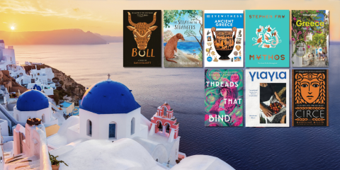 A grid of eight book cover images (five on the top row, three on the bottom) overlays a landscape photo taken on a Greek island. The viewer looks out over white and blue buildings, the ocean, and a sun setting behind hills in the distance. 
