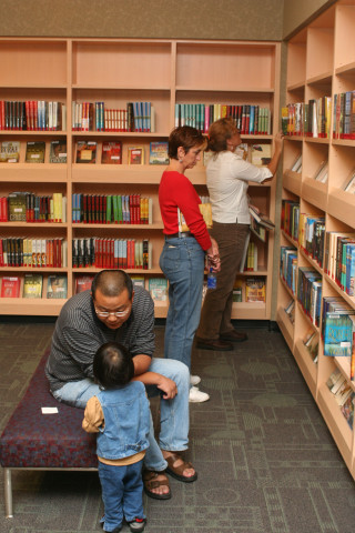 Patrons browse shelves at a library.